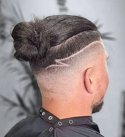 MAN BUN WITH UNDERCUT FADE AND ARTIST DESIGN